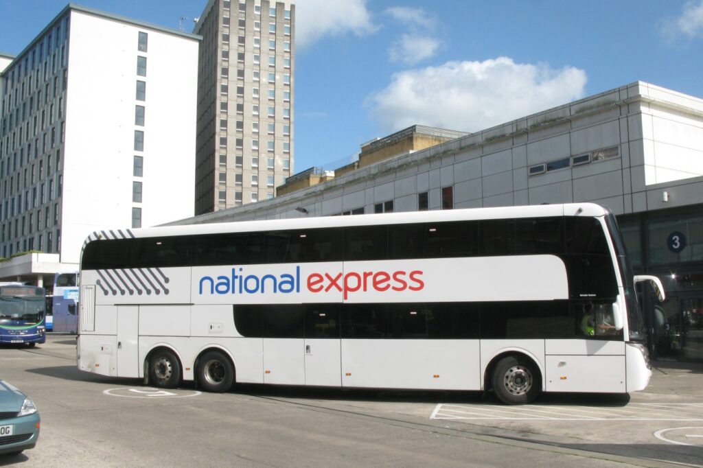 A white National Express coach parked in a city