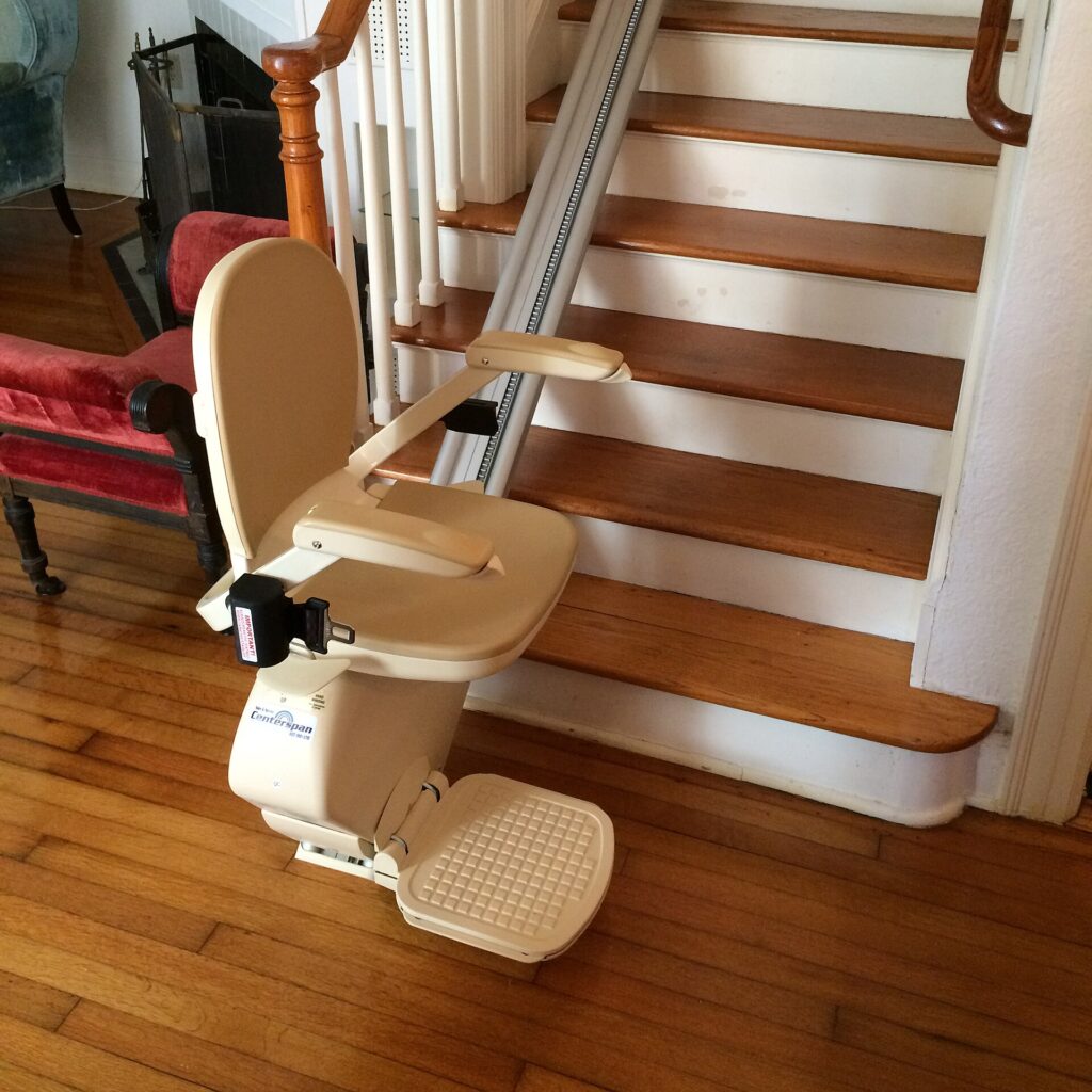 A stairlift fitted to a wooden staircase in a home