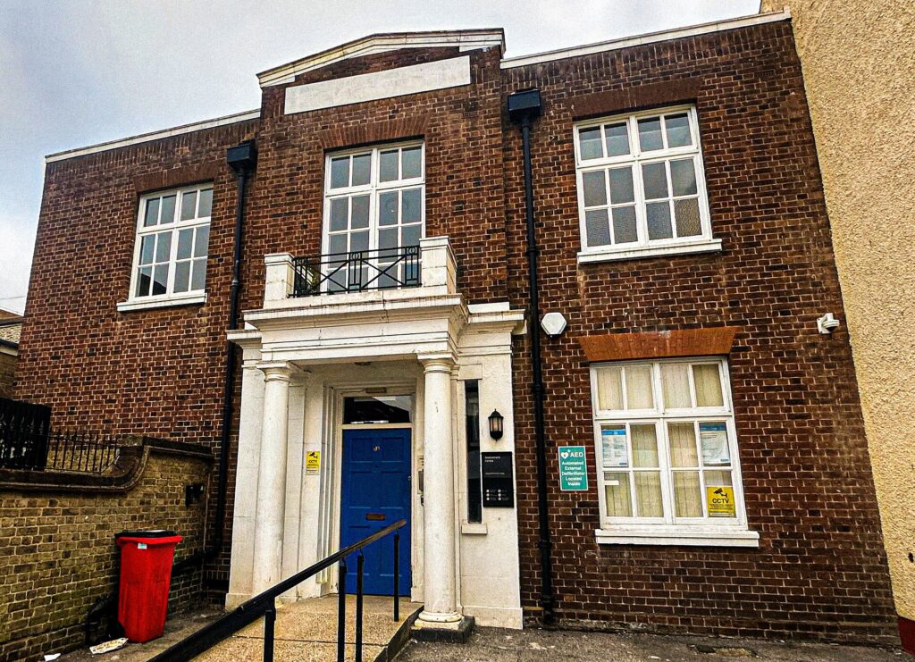 The brick front of a PIP medical assessment centre with steps up to the door