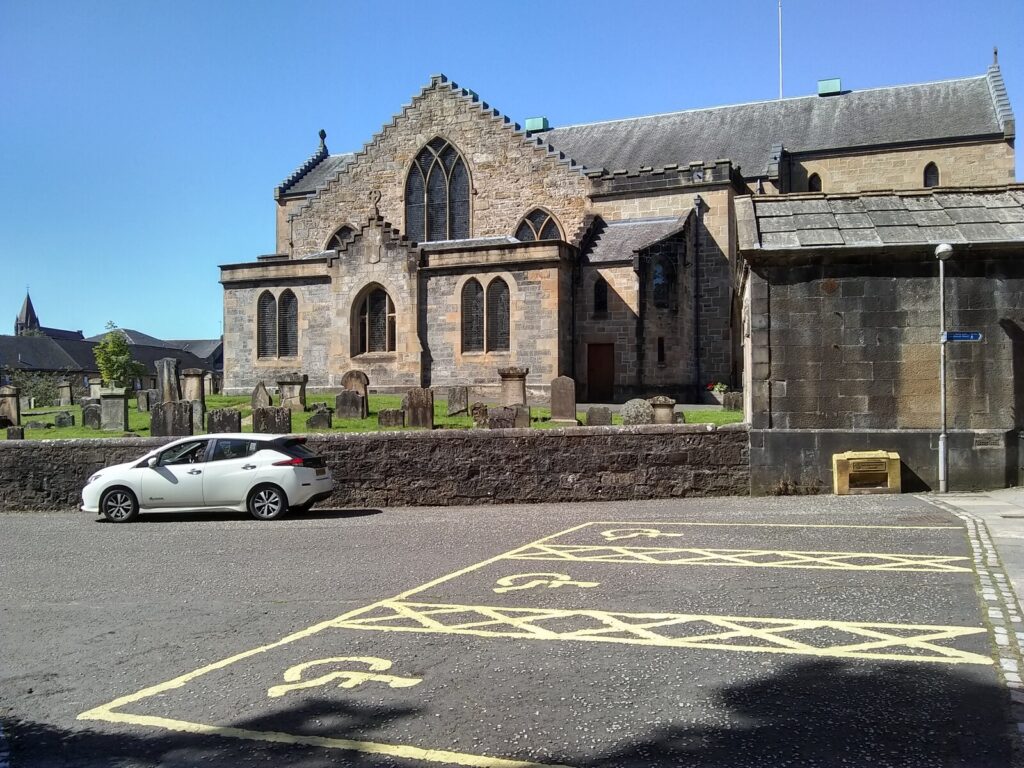 A row of marked disabled parking bays in a car park