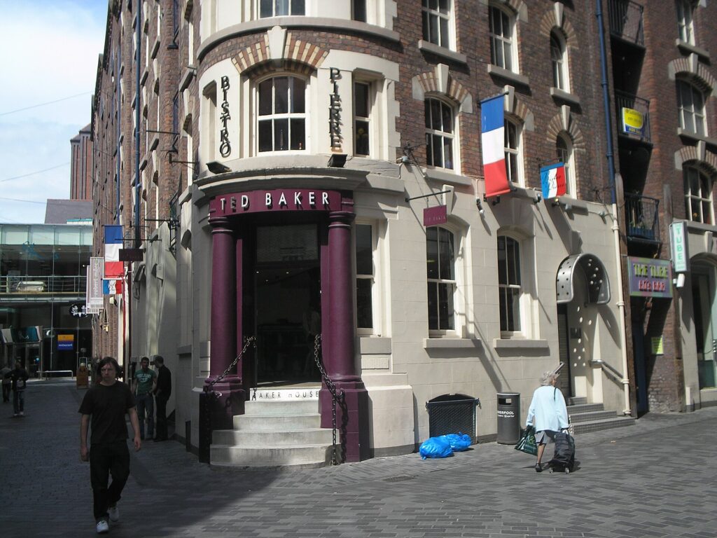 A shop on a Liverpool street with steps up to its front door