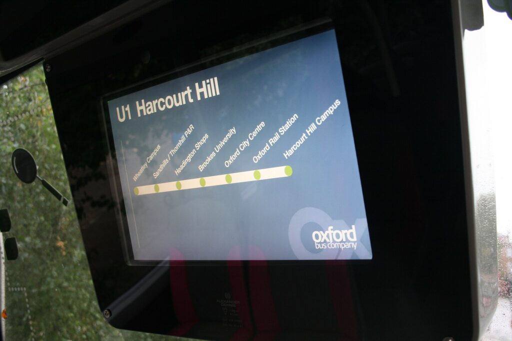 A screen on a bus showing the upcoming stops on the route