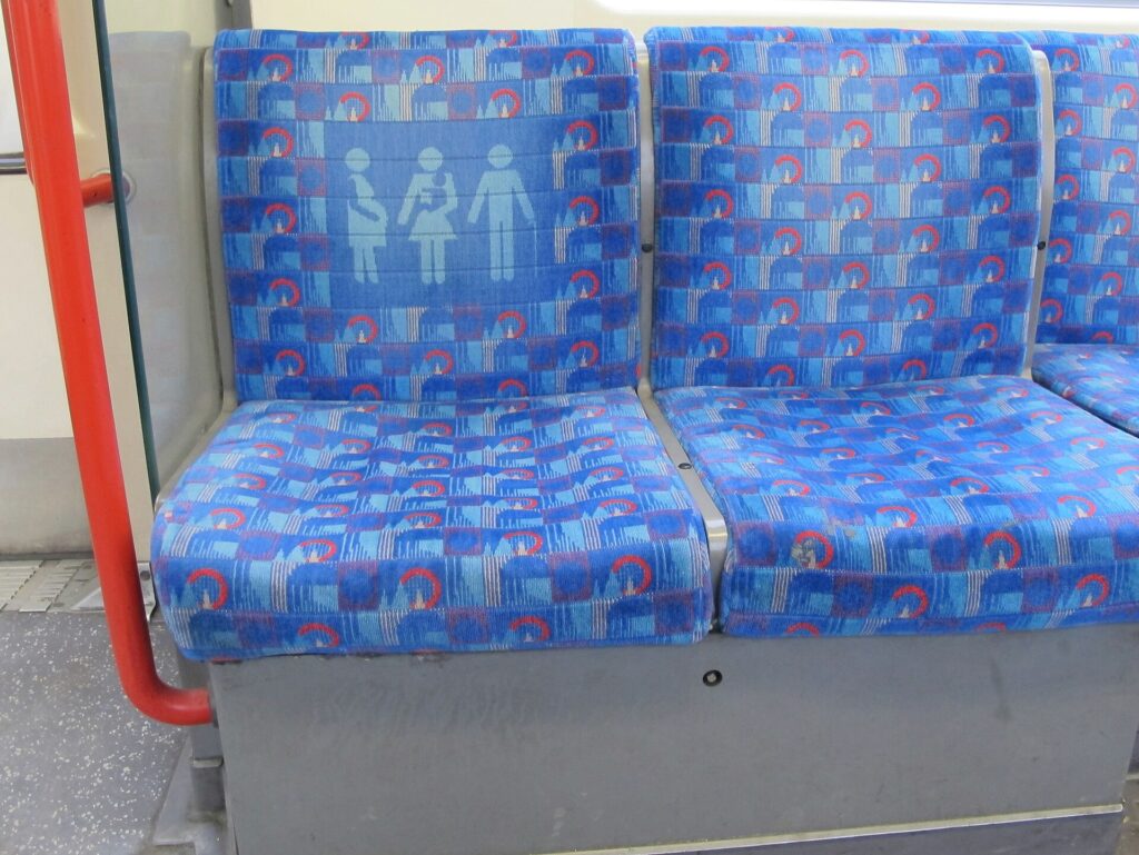 London Underground seat fabric with a priority seat pictogram showing people who may need a seat